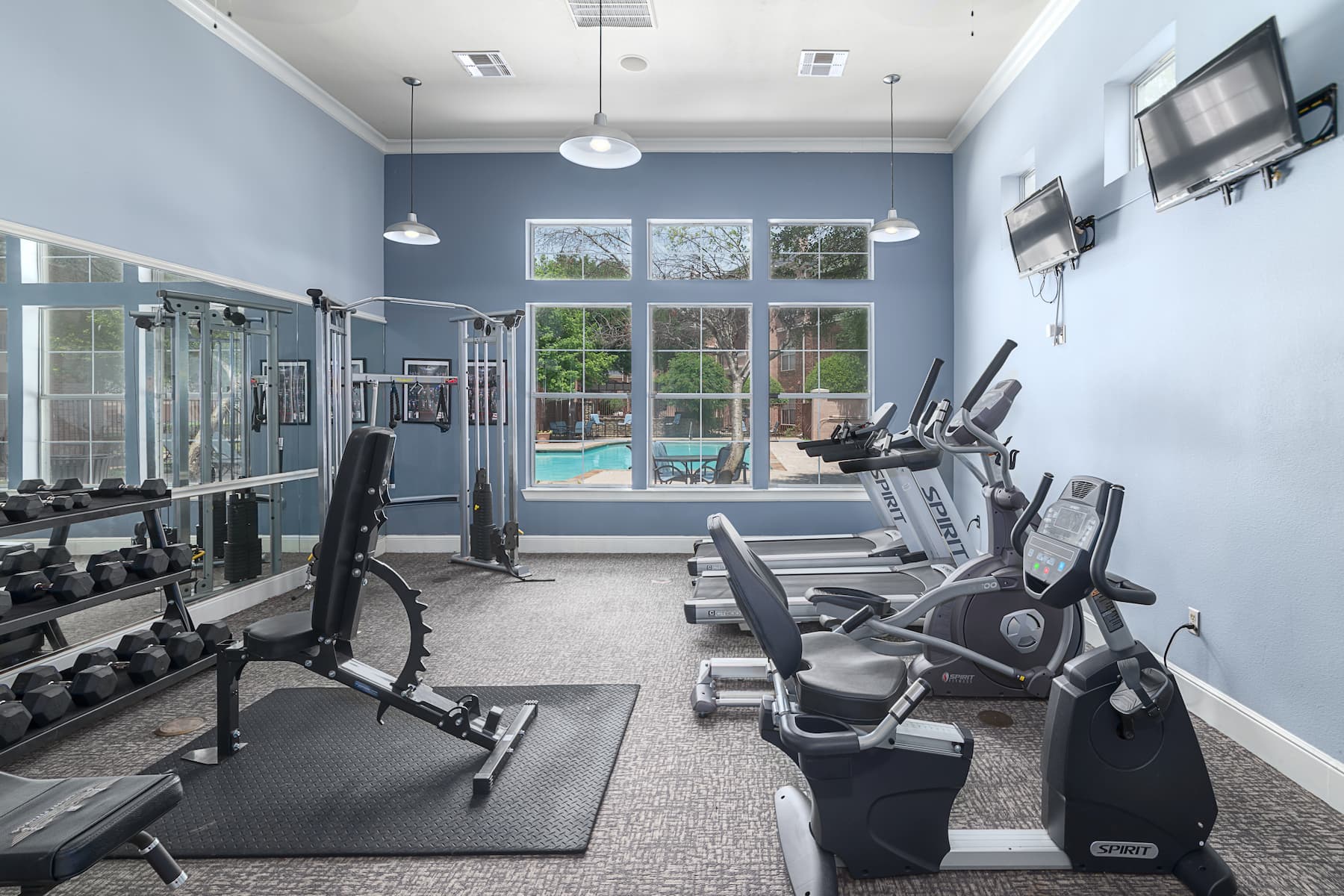 get your daily exercise routine done in our fitness room with modern equipment nearby our resort-style pool